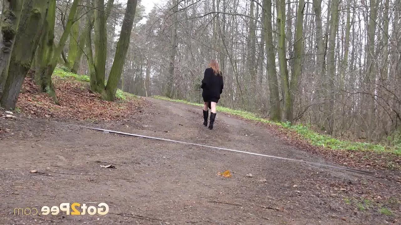 15P Caucasian girl Yenna pisses on a pathway through the woods