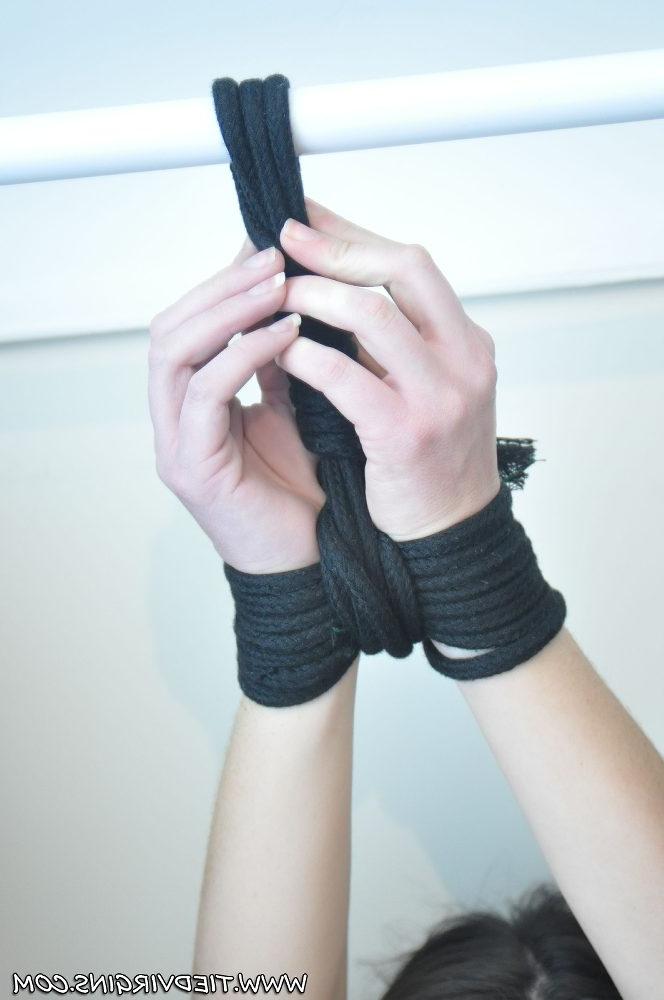 12P Brunette chick has her wrists tied above her head with a gag in her mouth