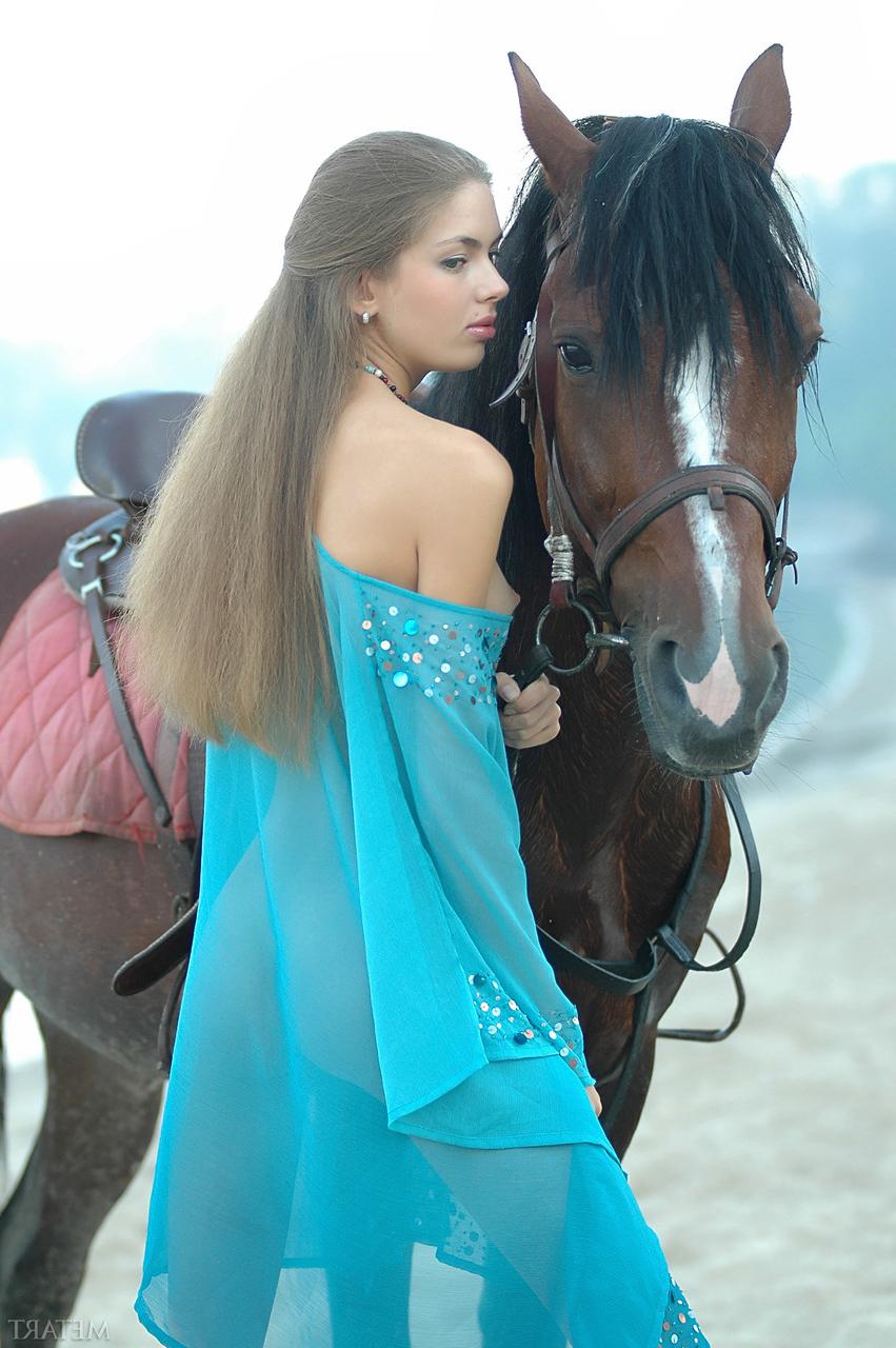 17P Alena, une fille blanche et mince, se met seins nus tout en s'occupant de ses chevaux.