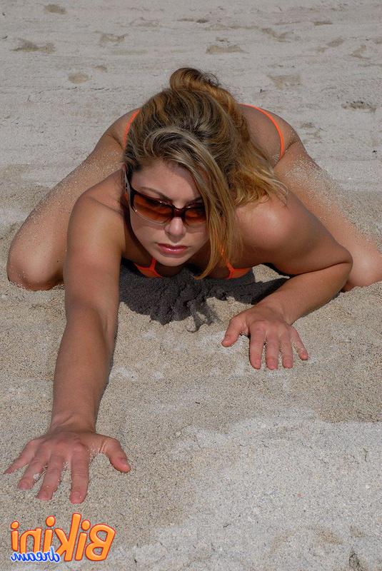 15P Die heiße Strandschönheit Amber posiert im knappen Bikini auf den Knien im Sand