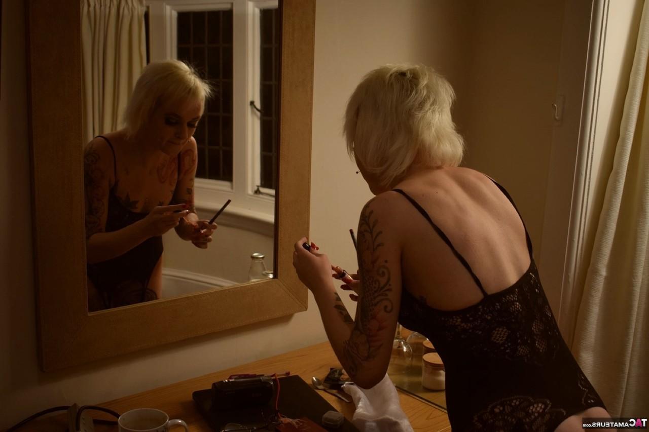 16P Tattooed blonde models sensual lingerie and hosiery during a solo shoot