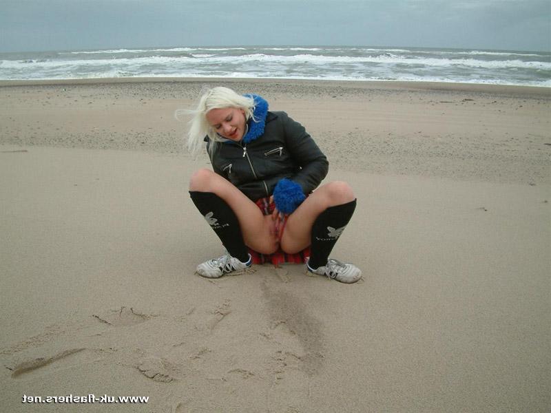 12P Blonde girl pisses on a beach and upon dune grass as well