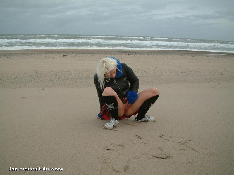 12P Blonde girl pisses on a beach and upon dune grass as well