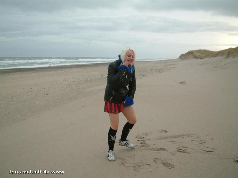 12P Blonde girl pisses on a beach and upon dune grass as well