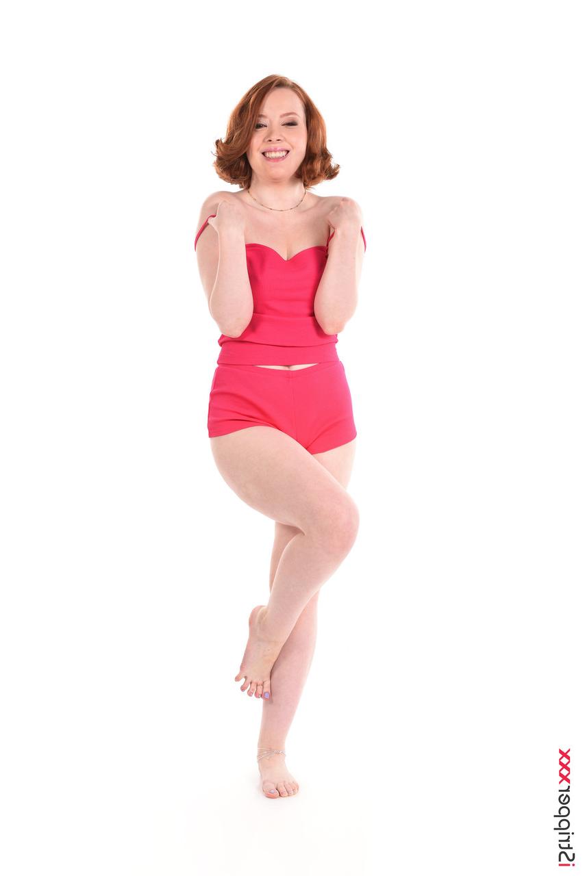 15P Natural redhead Lottie Magne strips naked before toying her trimmed muff