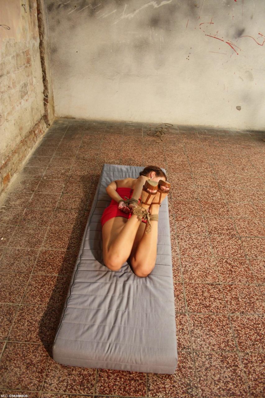 20P Ball gagged & hog tied babe Jenny struggles to get free from her restraints