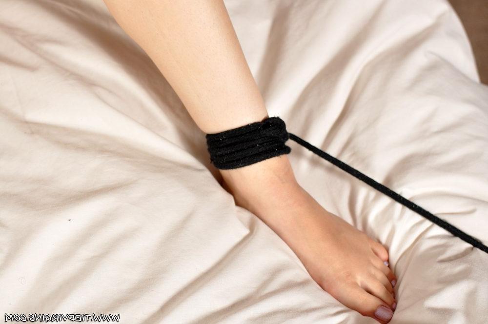 12P Caucasian girl is tied to a bed in just a thong while ball gagged