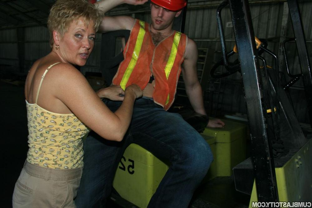 12P Short haired woman Tracy sucks on a forklift operator's dick in a warehouse