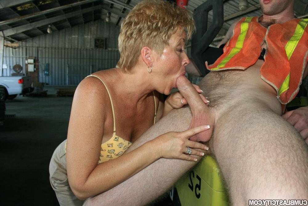 12P Short haired woman Tracy sucks on a forklift operator's dick in a warehouse