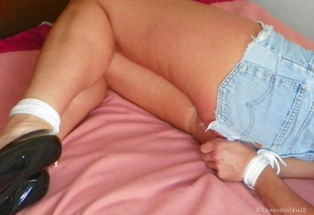 15P Clothed female is gagged while tied up with rope on a single bed
