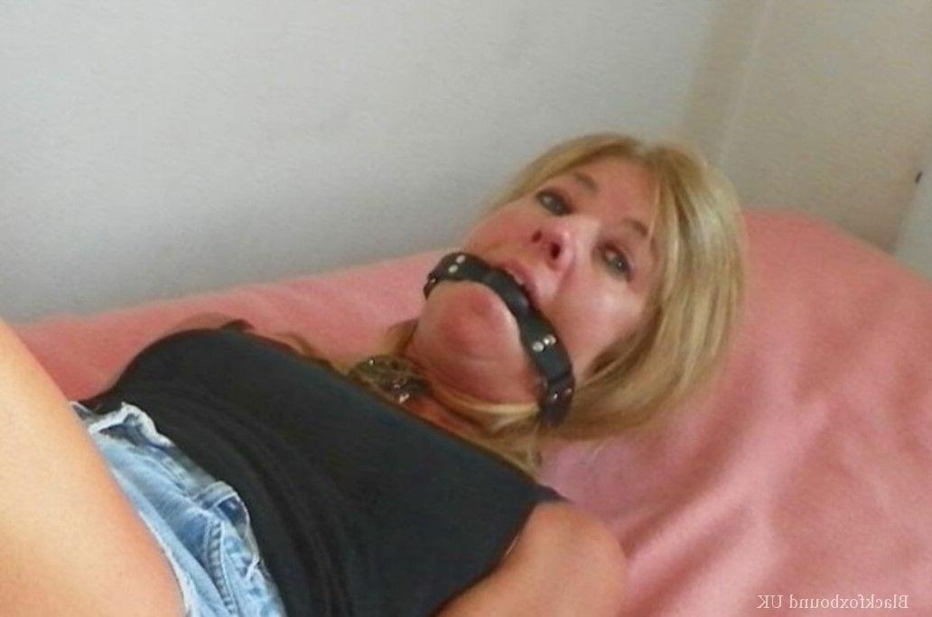 15P Clothed female is gagged while tied up with rope on a single bed