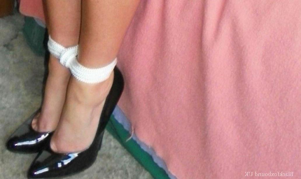 15P Clothed female is gagged while tied up with rope on a single bed