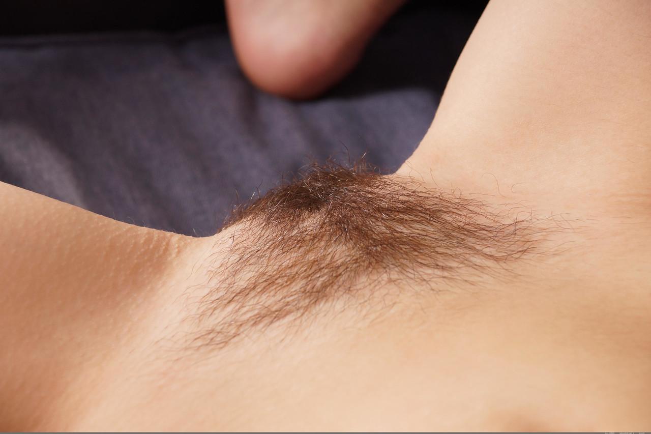 20P Beautiful curly-haired teen Sherie shows her inviting hairy pussy up close