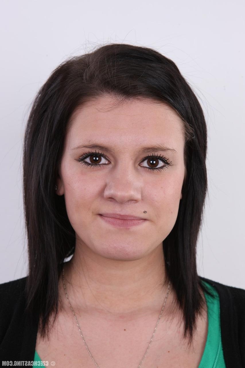 20P Cute brunette Lucie stands fully clothed before getting bare naked