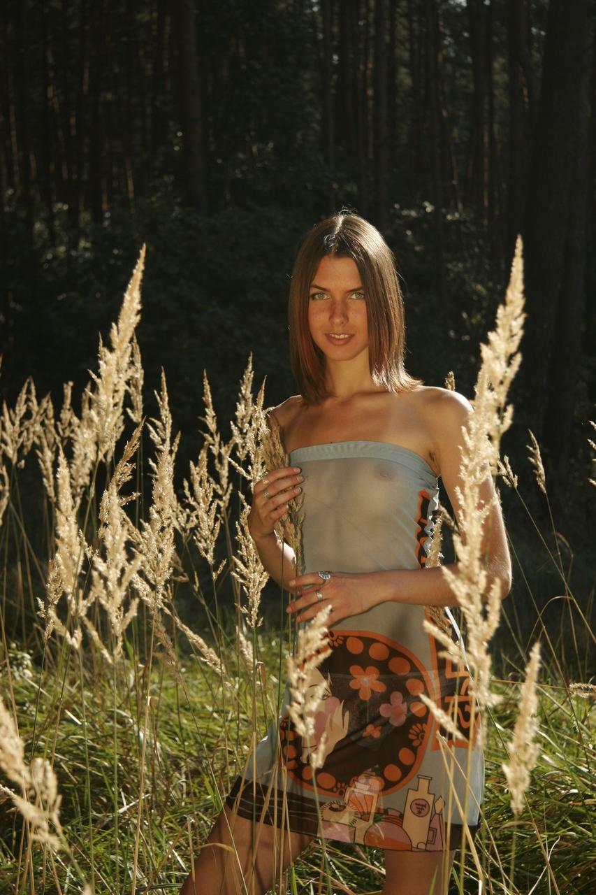20P Slender teen with small tits Nana unveils her bum and poses in the woods