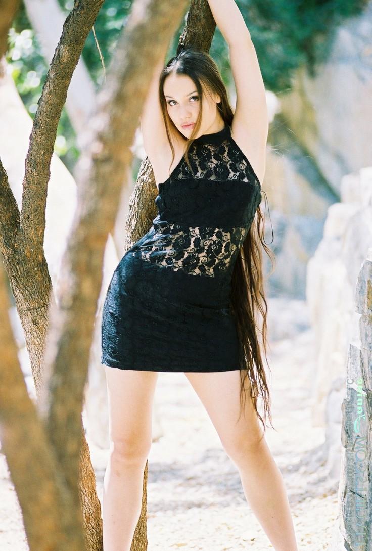 20P Glamorous beauty Janine posing pantyless in a black dress in nature