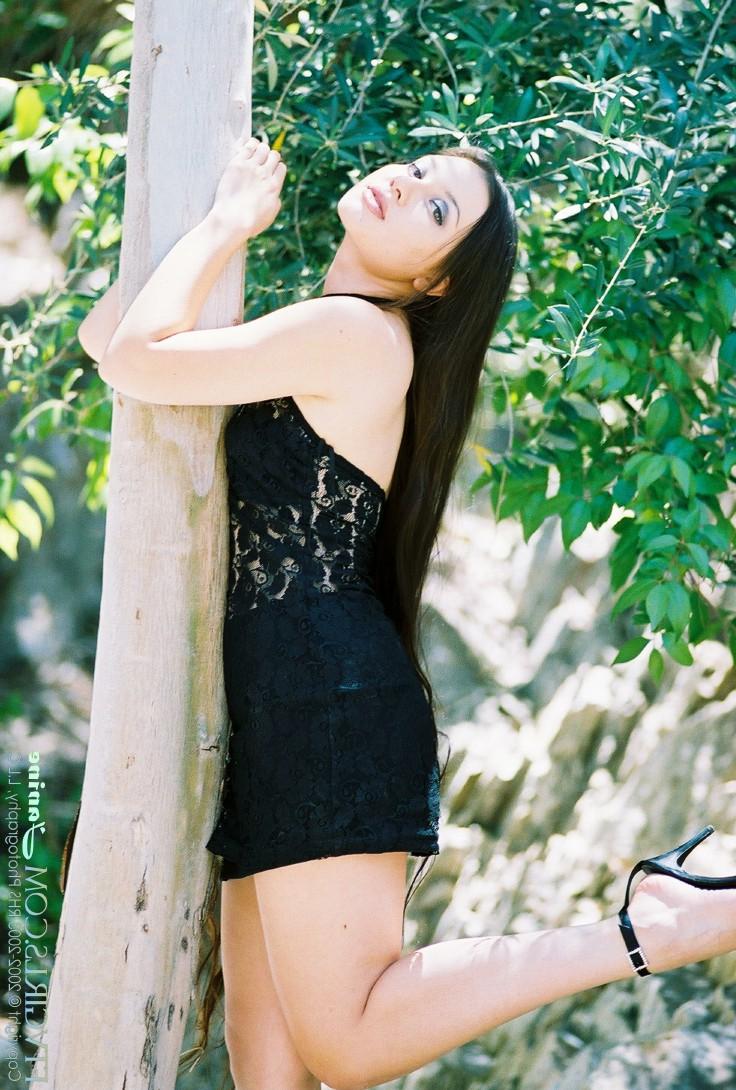 20P Glamorous beauty Janine posing pantyless in a black dress in nature