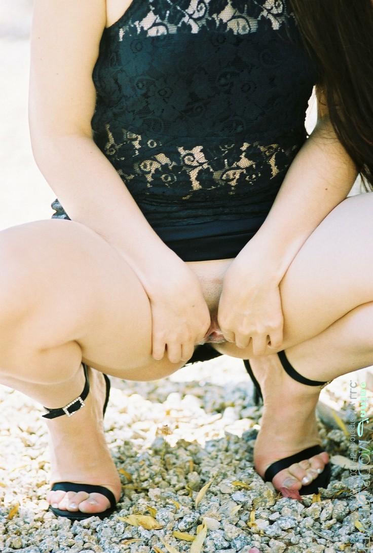 20P Glamorous beauty Janine posing pantyless in a black dress in nature
