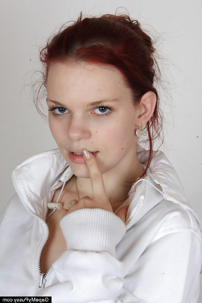 16P Sassy redhead girlie in nylons undressing and stretching her pink cunt