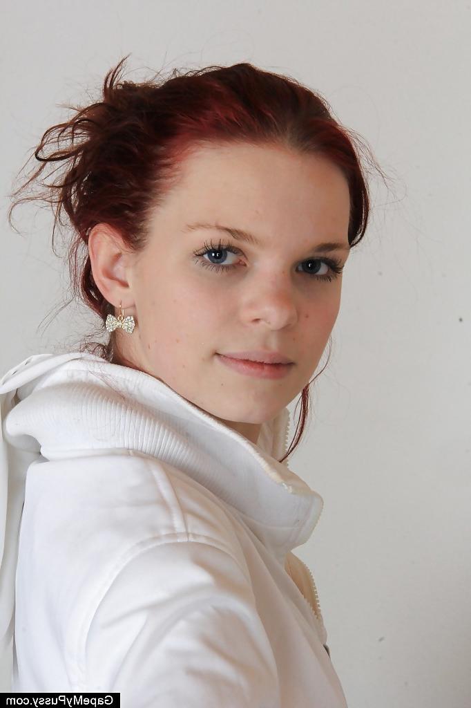 16P Sassy redhead girlie in nylons undressing and stretching her pink cunt