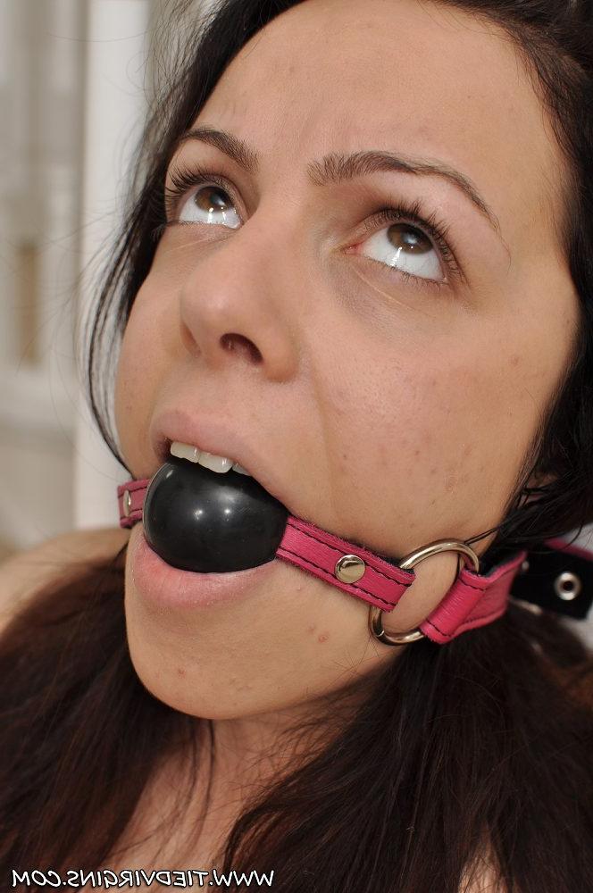 12P Busty brunette struggles against a ball gag while tied to a railing