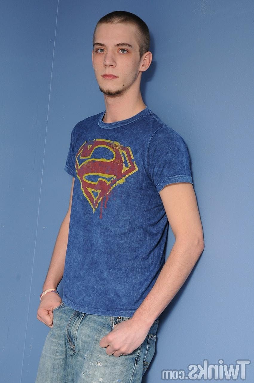 20P Shaved-headed gay model Gemini Star strips & exposes his big curved dick