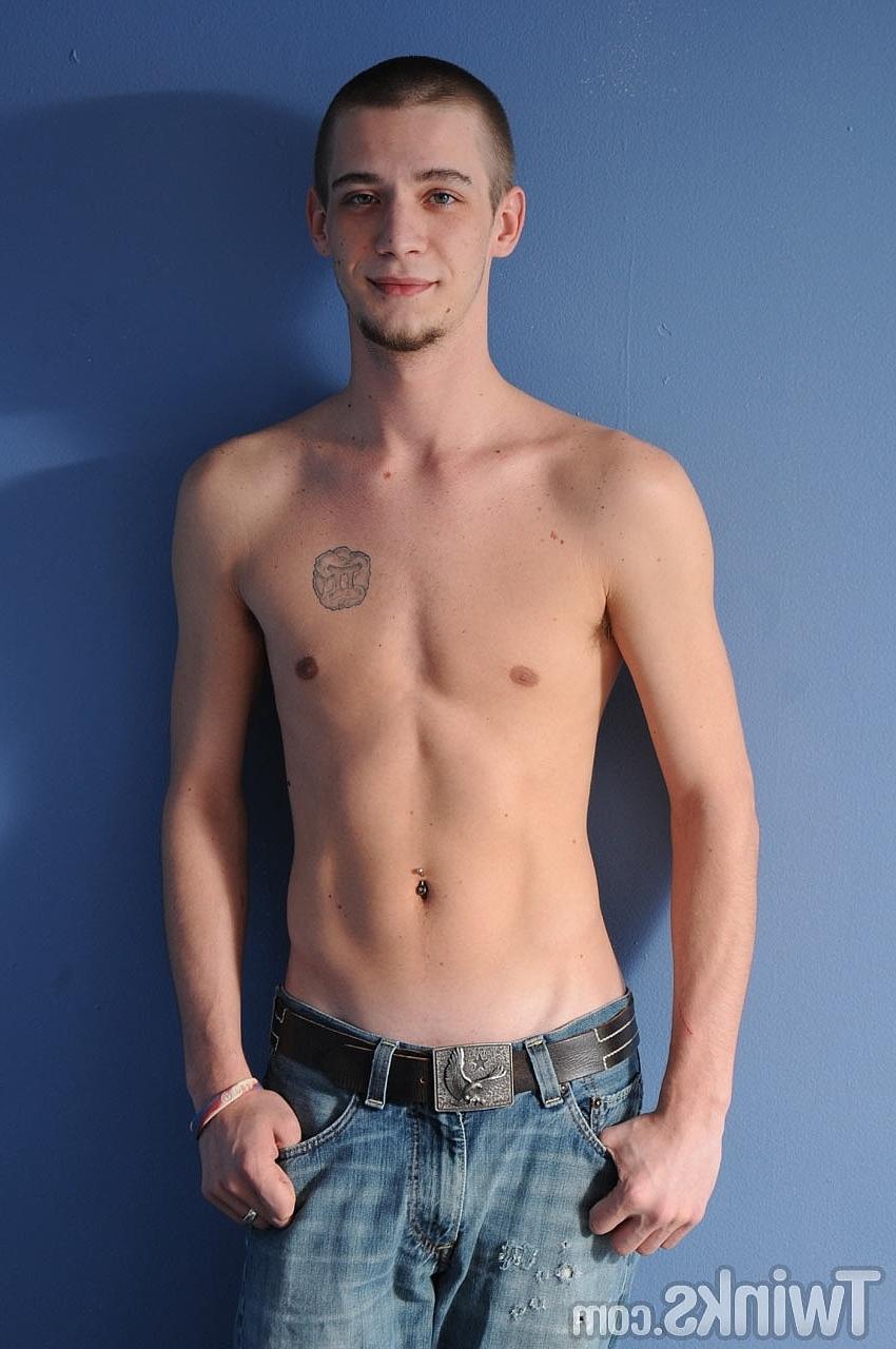 20P Shaved-headed gay model Gemini Star strips & exposes his big curved dick