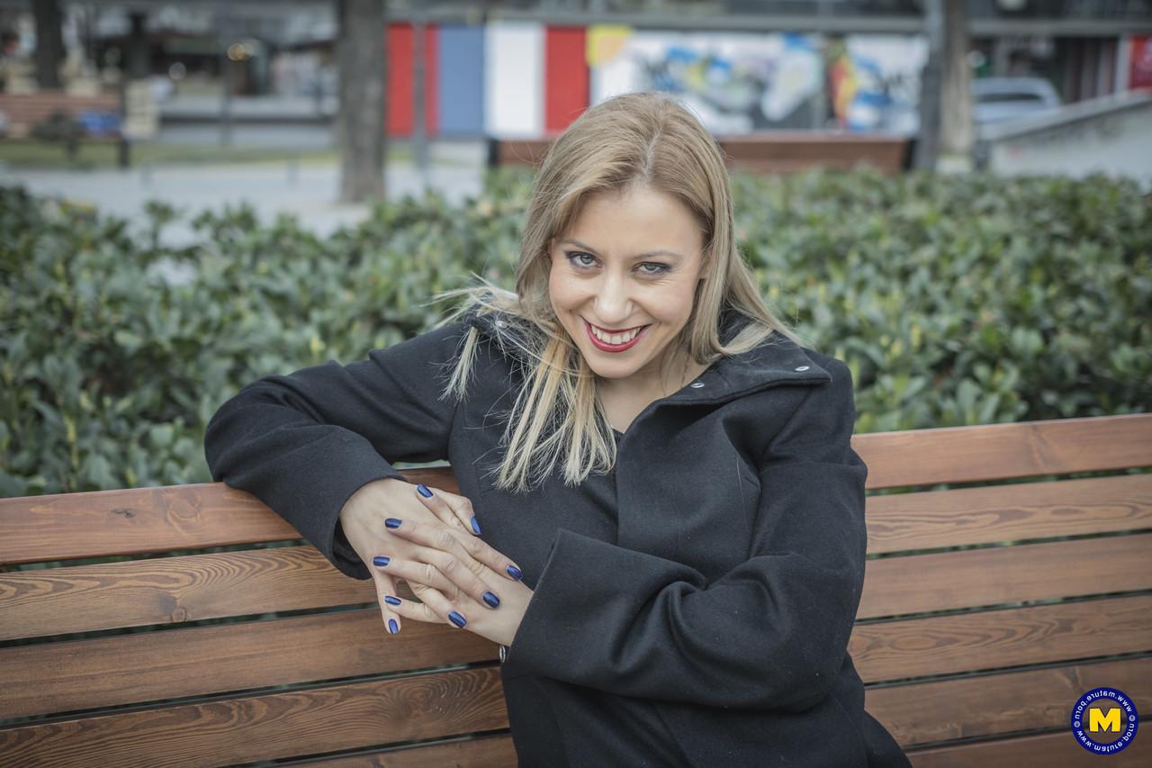 18P A sexy mãe europeia Nadina posa com seu casaco preto, botas e meias em público
