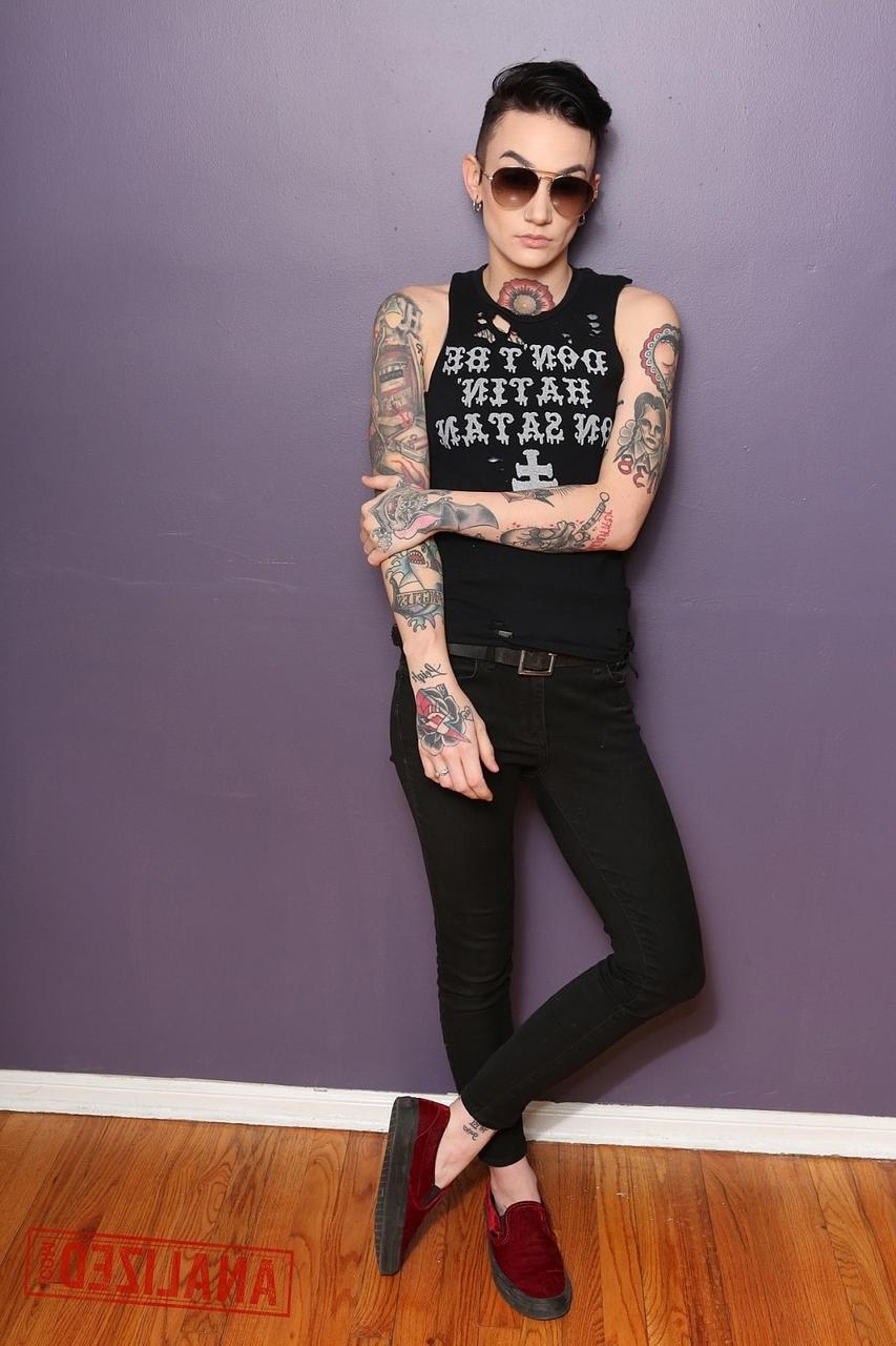 17P Androgynous model Nikki Hearts shows her tattoos and the butt plug up her bum