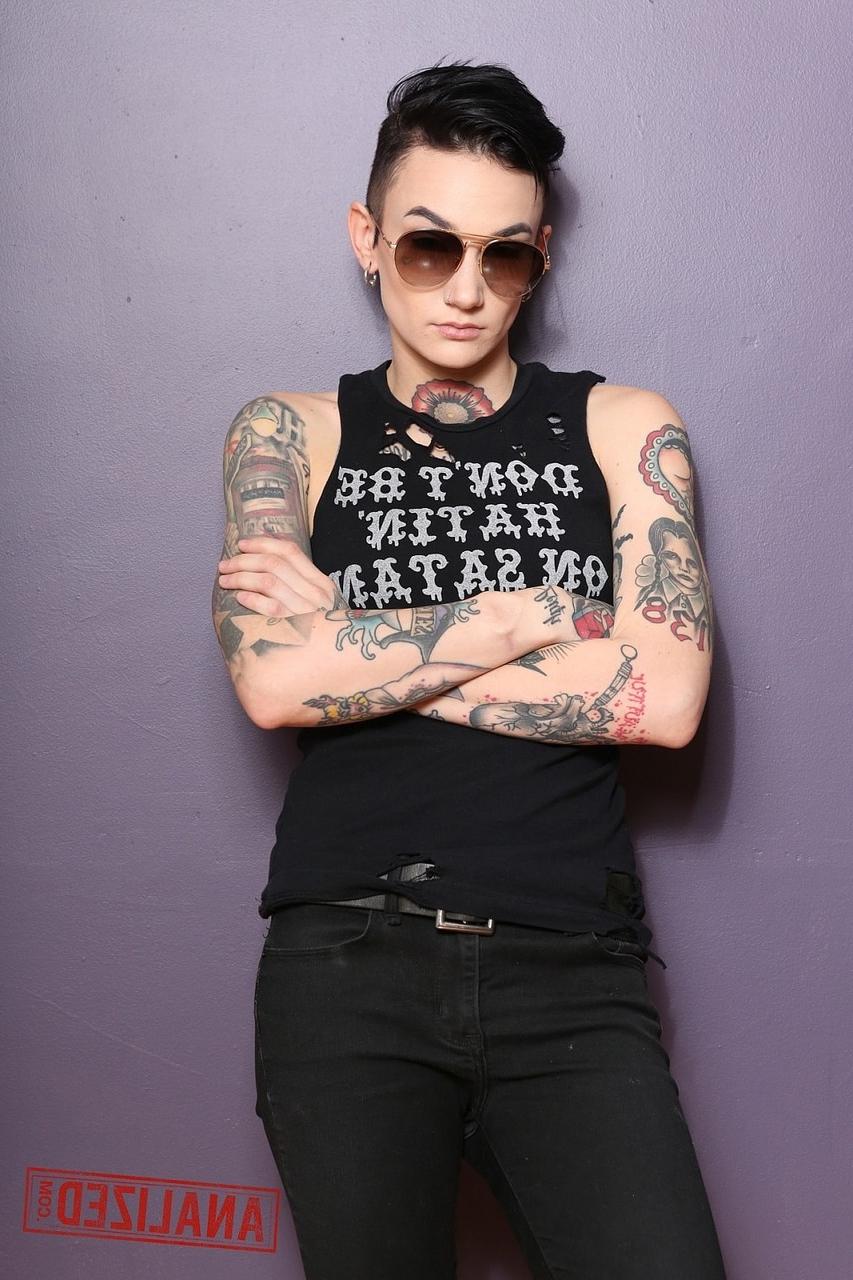 17P Androgynous model Nikki Hearts shows her tattoos and the butt plug up her bum