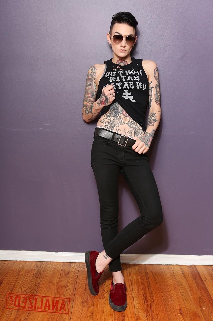 17P Androgynous model Nikki Hearts shows her tattoos and the butt plug up her bum