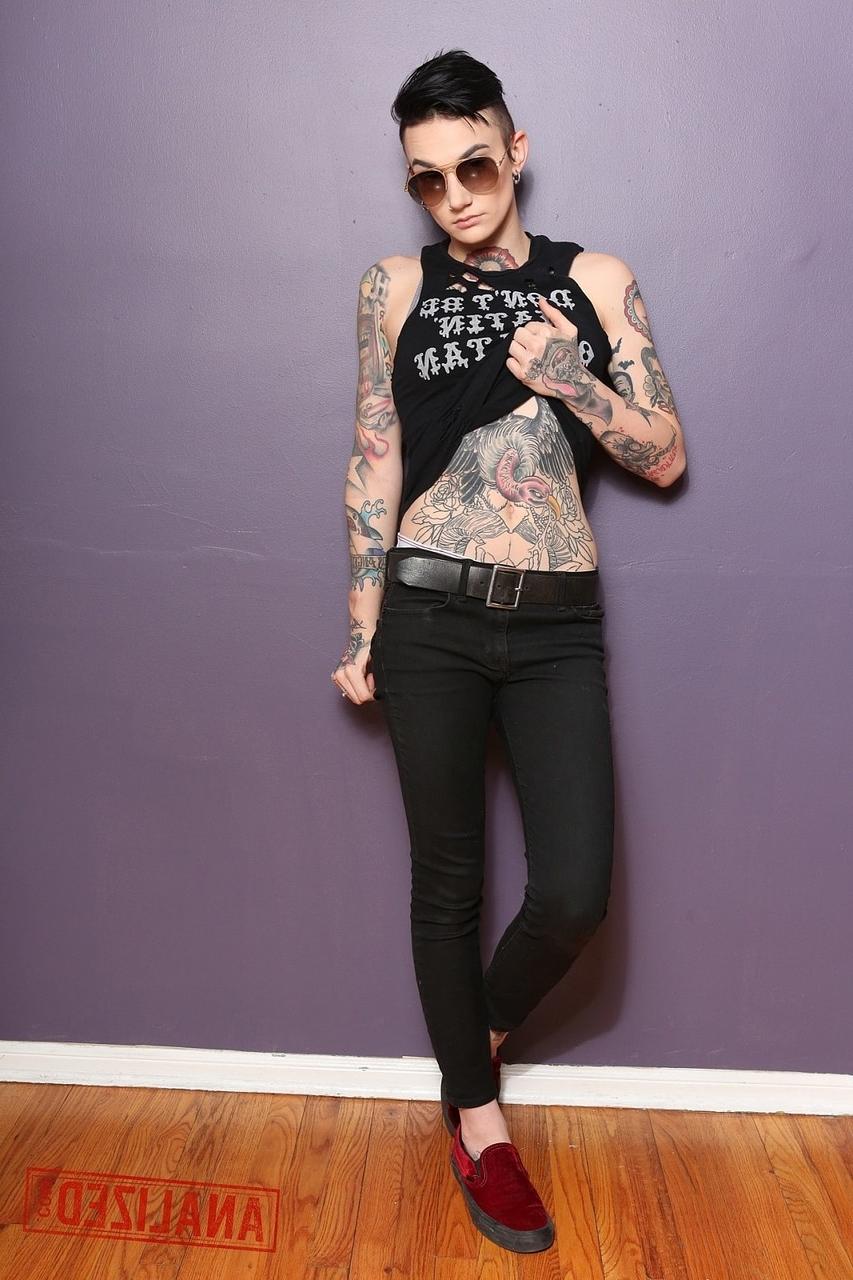 17P Androgynous model Nikki Hearts shows her tattoos and the butt plug up her bum