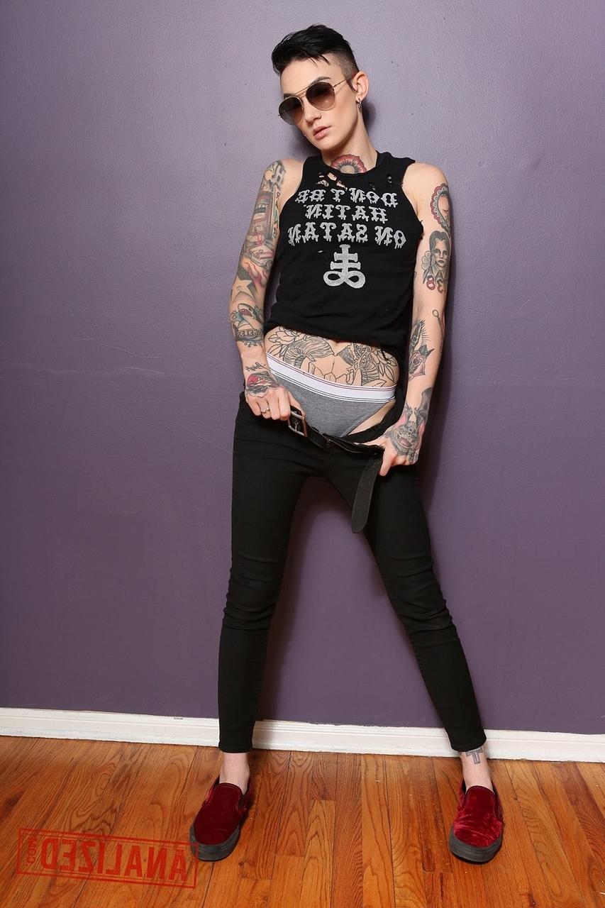 17P Androgynous model Nikki Hearts shows her tattoos and the butt plug up her bum