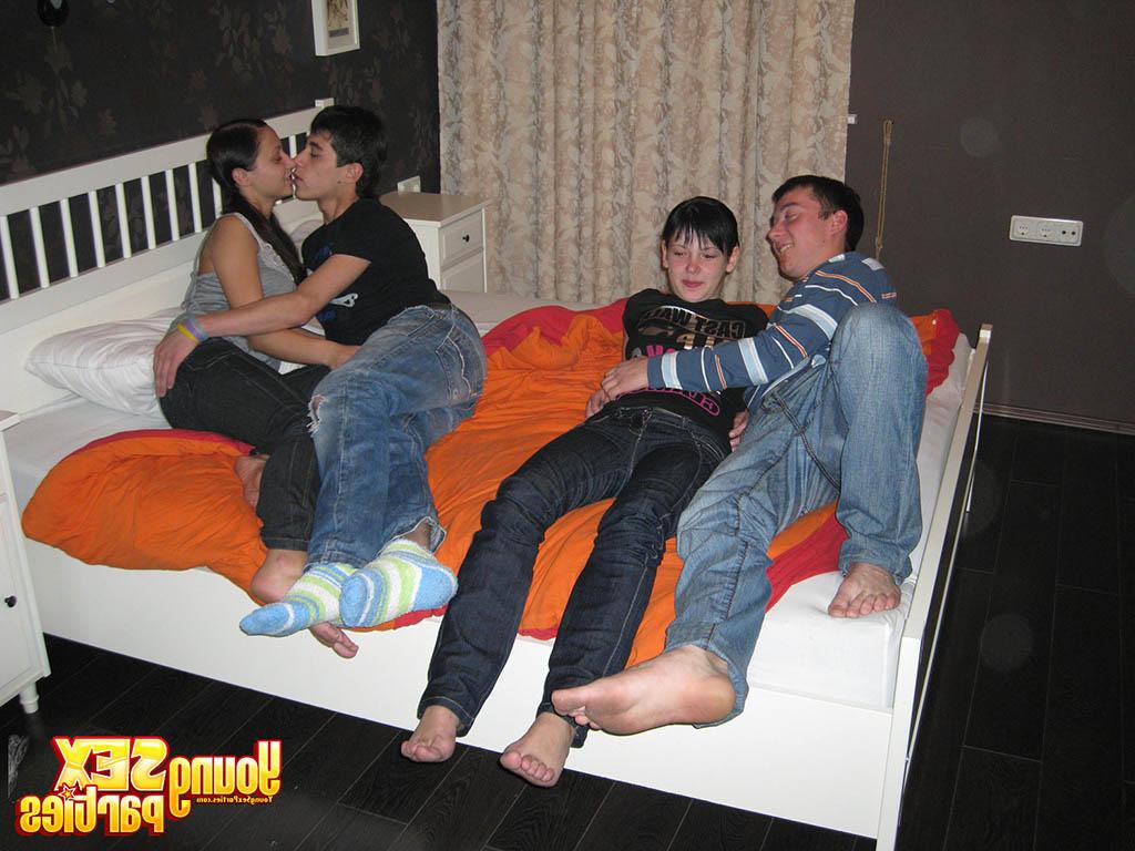 16P Young brunettes and their boyfriends have foursome sex on top of a bed