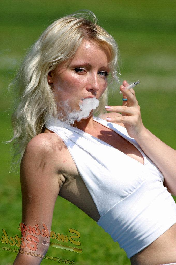 15P Hot blonde smokes a cigarette during upskirt action on a public bench