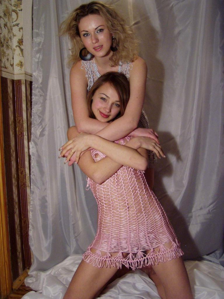 18P Teen lesbians snuggle on a bed while wearing revealing dresses