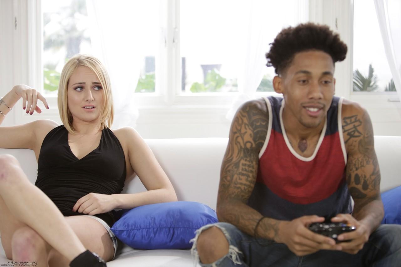 20P Blonde chick Kate England seduces a black stud while he plays video games