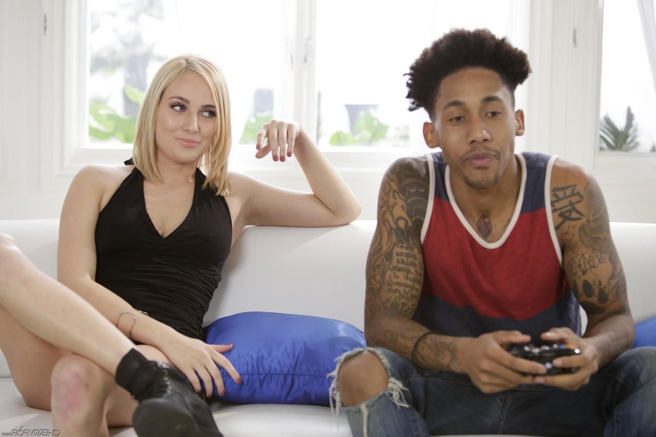 20P Blonde chick Kate England seduces a black stud while he plays video games