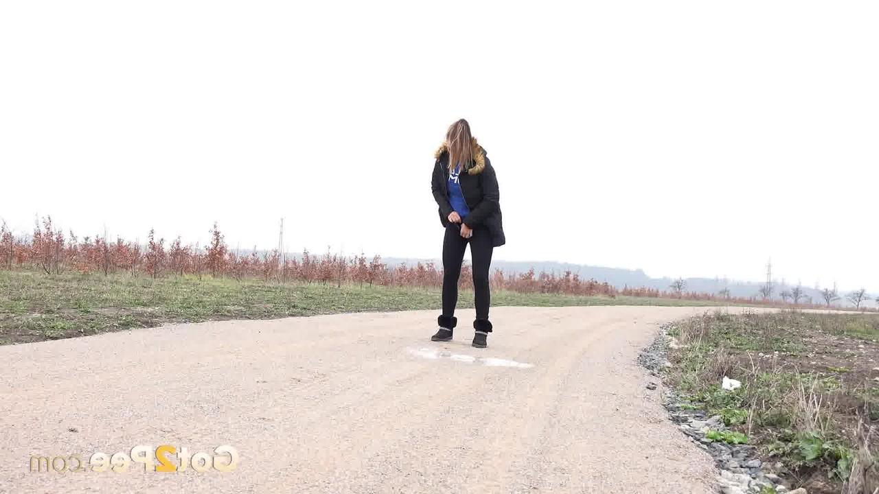 15P Fully clothed girl Naomi Bennet pulls down her pants to piss on a dirt road