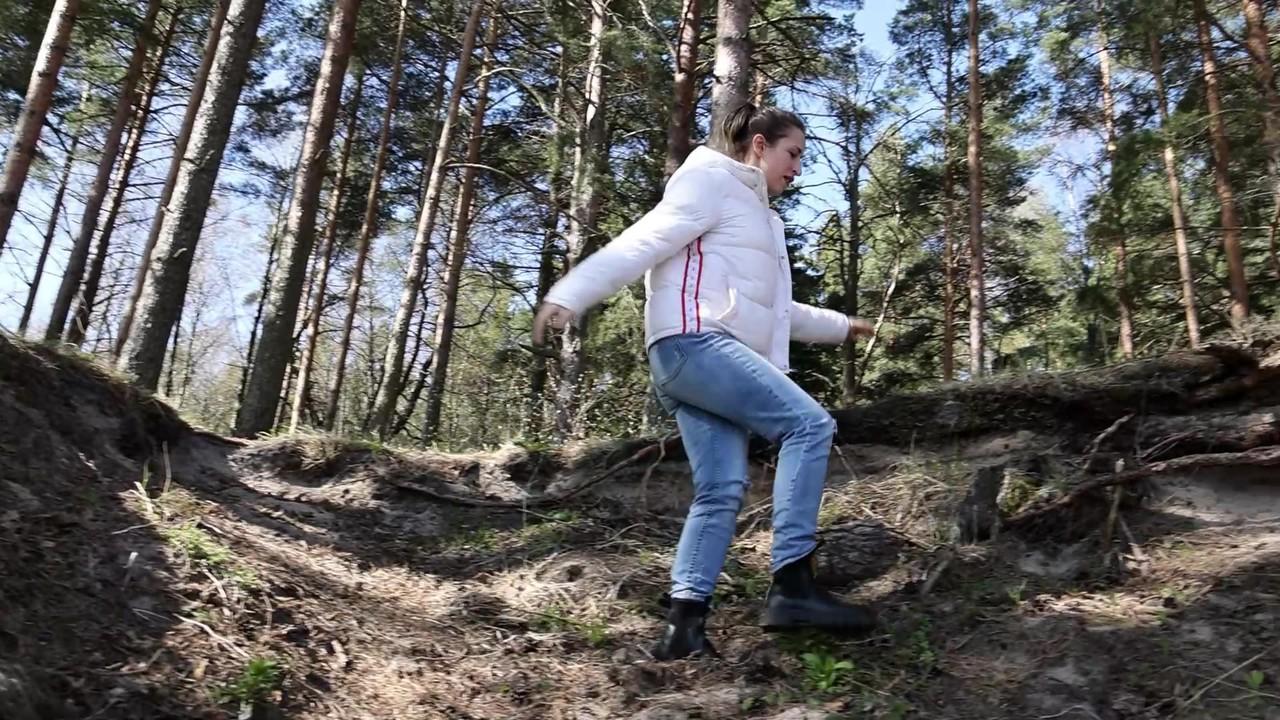 15P Brunette chick Katy Dee takes a badly needed pee over a bank in the woods