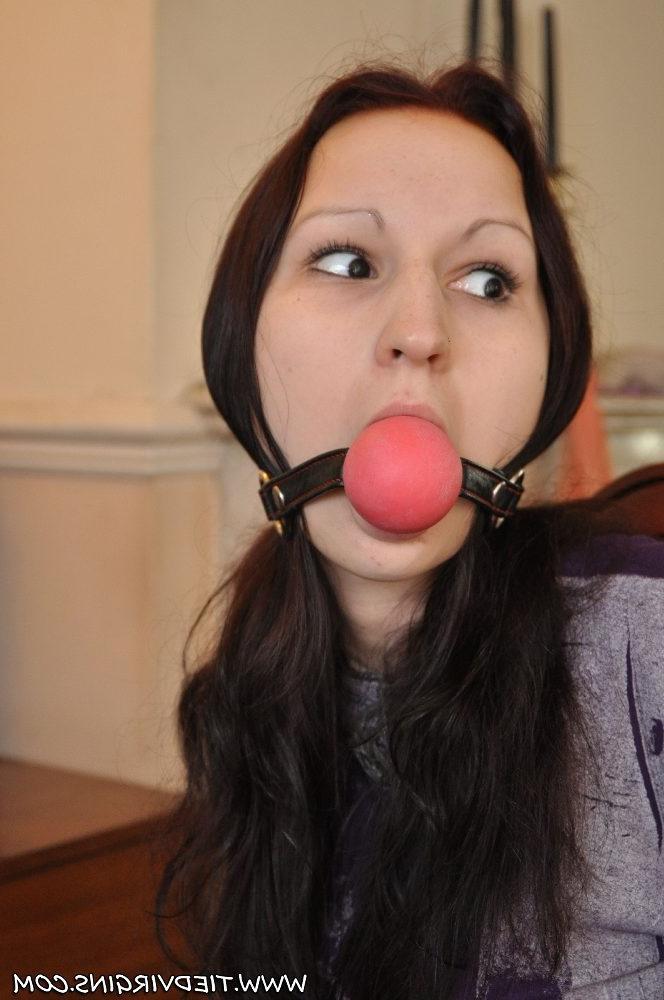 12P Caucasian girl is tied to a chair with a big ball gag in her mouth