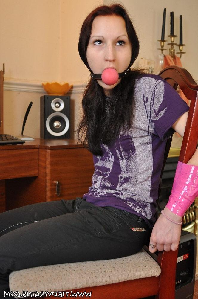 12P Caucasian girl is tied to a chair with a big ball gag in her mouth