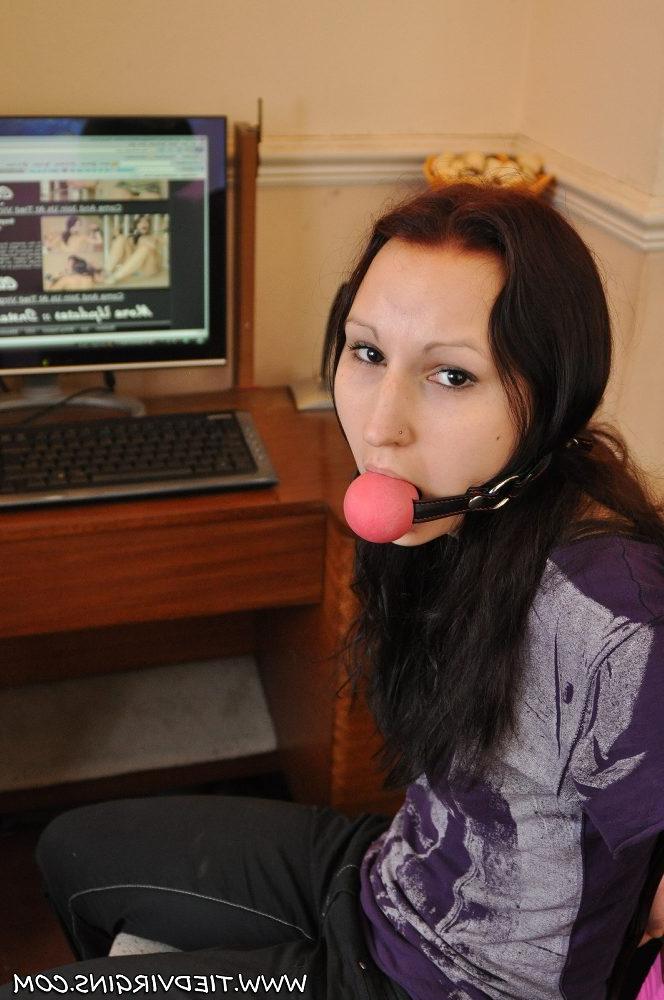 12P Caucasian girl is tied to a chair with a big ball gag in her mouth