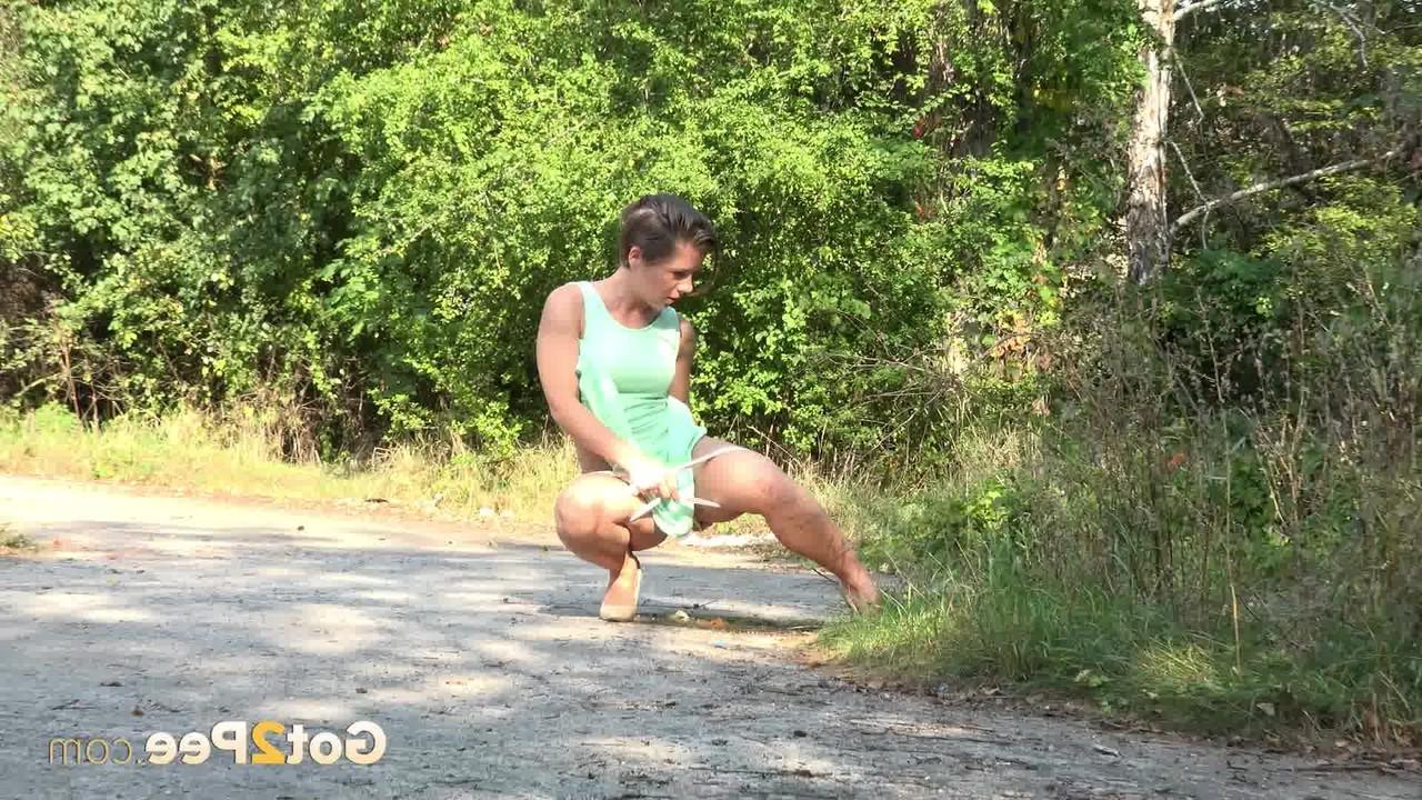 15P White chick pulls down her panties and squats for a piss on a country path