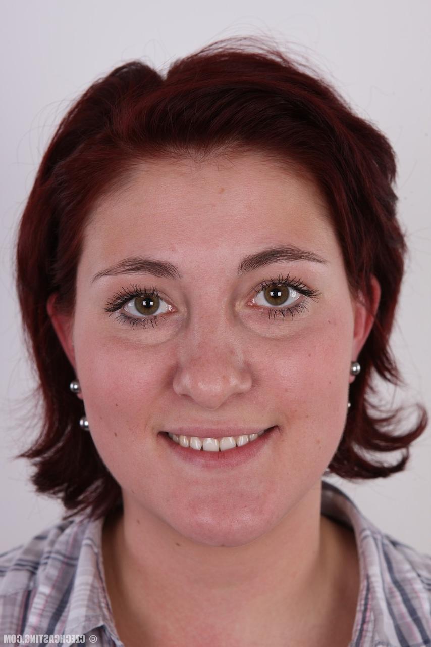 15P Redheaded amateur Martina stands fully clothed before a nude close up