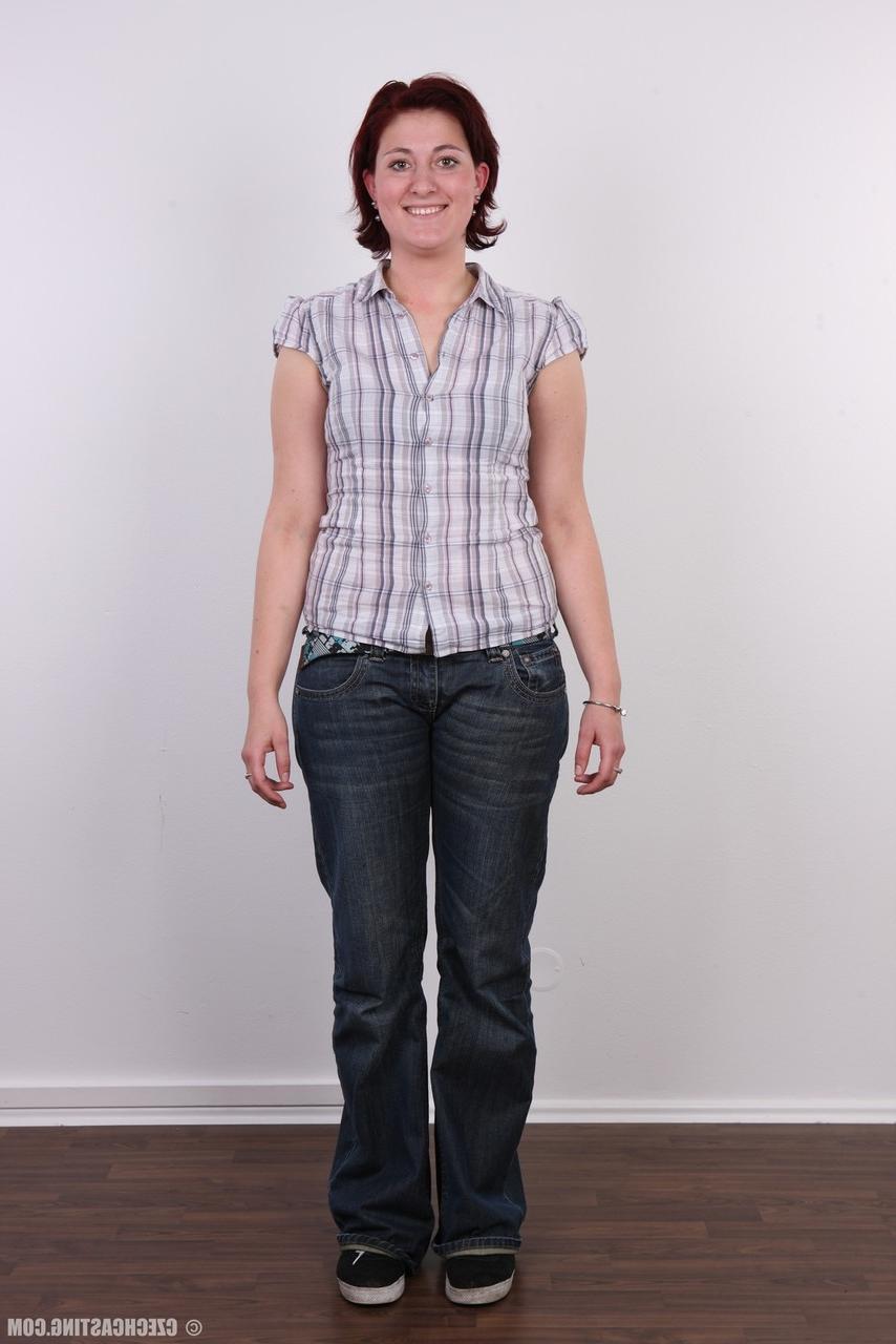 15P Redheaded amateur Martina stands fully clothed before a nude close up