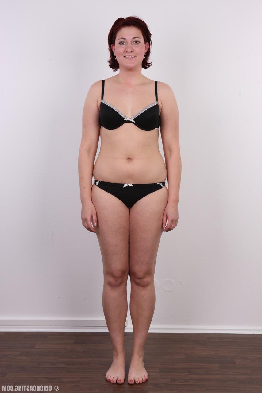 15P Redheaded amateur Martina stands fully clothed before a nude close up