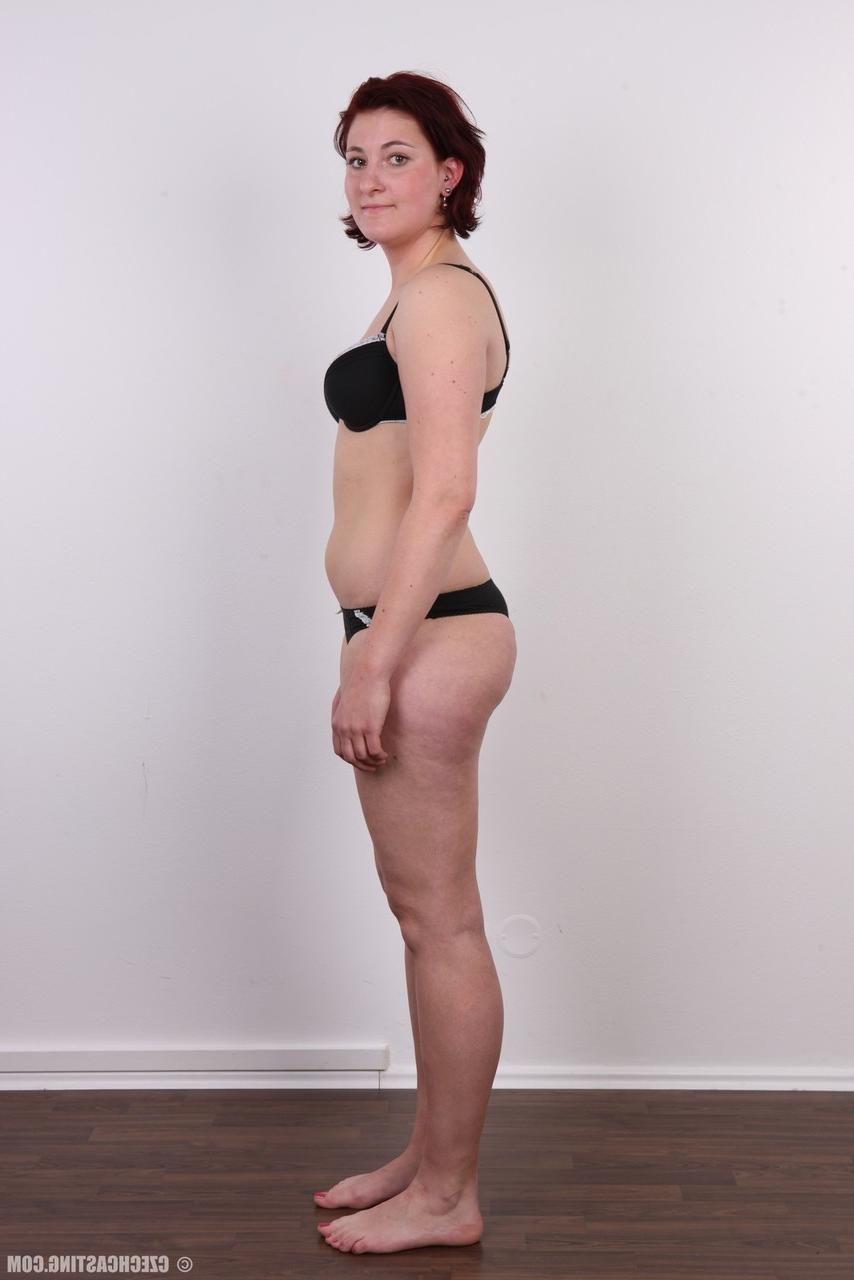 15P Redheaded amateur Martina stands fully clothed before a nude close up