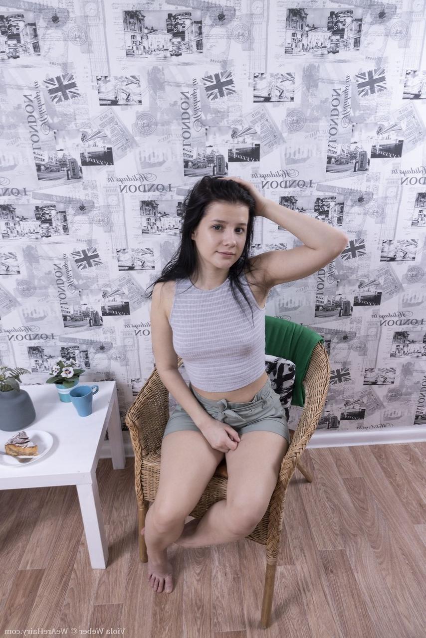 16P Young brunette Viola Weber uncovers her tiny tits before showing her bush