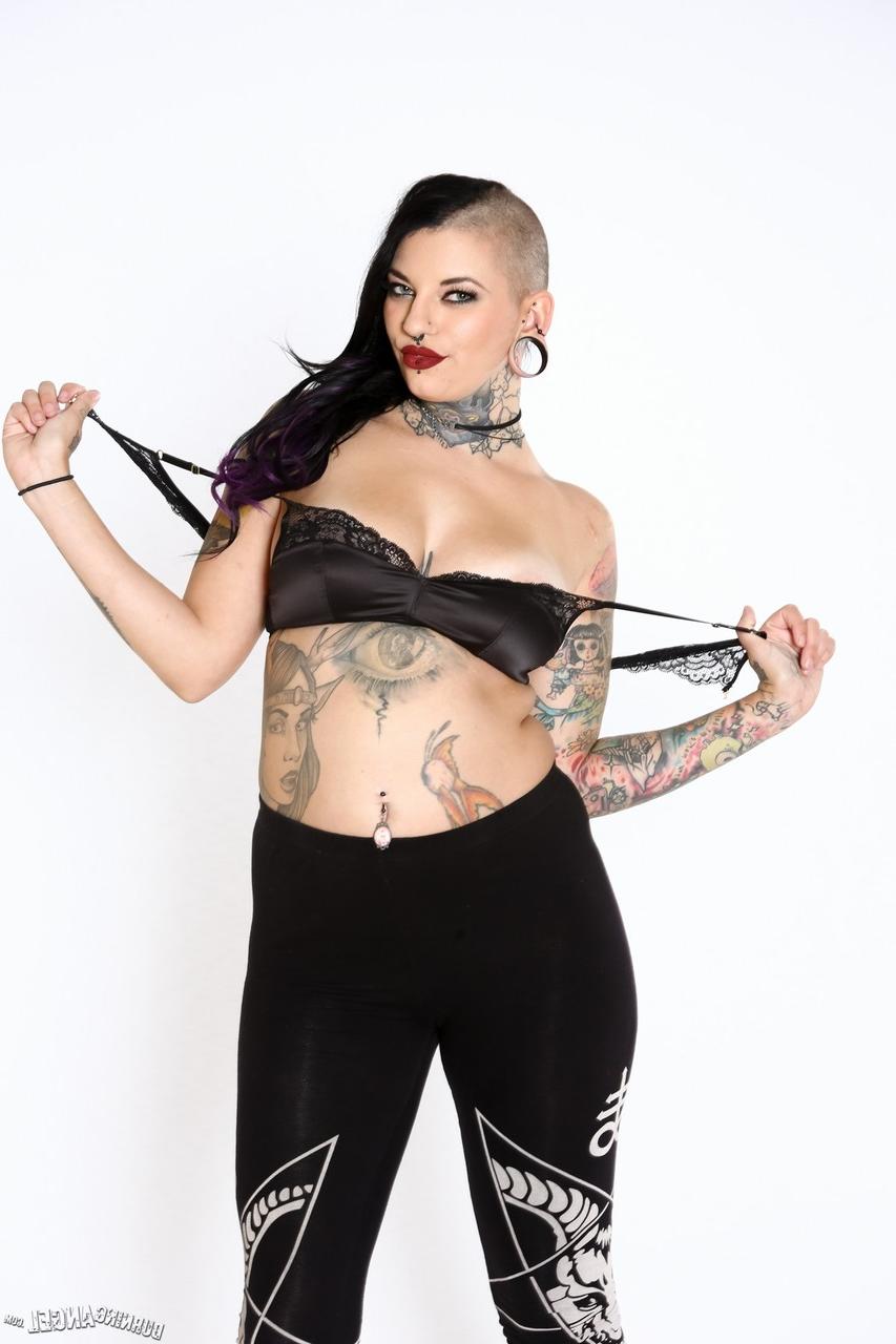 17P Alt model with a big butt and a half-shaved head exposes her tattooed body